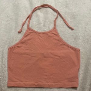 light orange tank top, that ties around you’re neck, and it’s cropped. Size XS